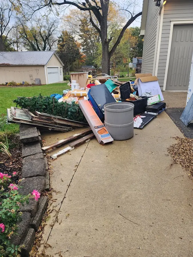Dumpster being loaded with debris for 30 Yard Dumpster Rental in Fredon